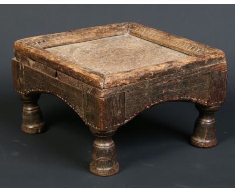 A 19th century African Tribal carved hardwood small square stool, raised on turned bell shaped feet, 28cm wide. Condition Rep