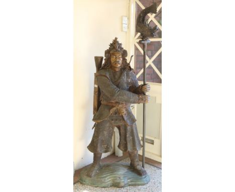A 20th century large bronze sculpture of a Mongolian warrior. Wearing armour, with a quiver of arrows and a staff, 173cm.