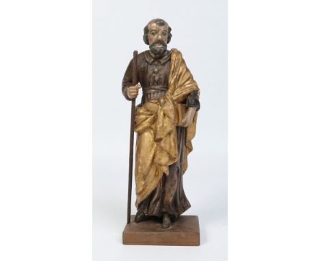 An 18th century Continental carved polychrome wood figure of a saint. Holding a staff, a book and dressed in a gilded robe, 3