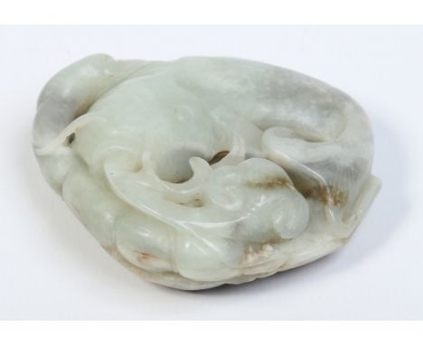 A Chinese celadon jade carving of a carp with a ruyi branch and decorated with a leaf to the back side. Brown suffusions to t