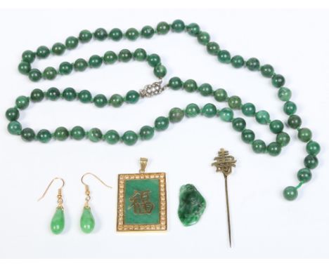 A collection of Chinese 20th century spinach jade and yellow metal jewellery. Including a double row bead necklace, a rectang