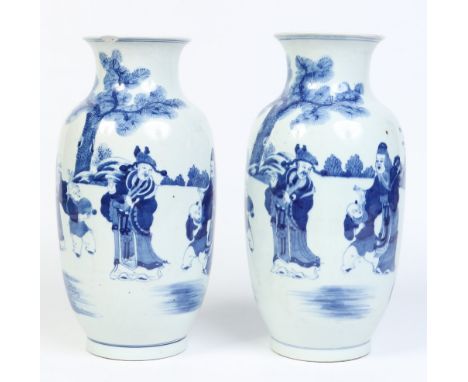 A pair of 19th century Chinese mantel vases. Painted in underglaze blue with scholars and children in landscapes with pine tr