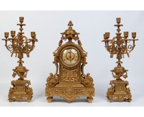 A 19th century French gilt bronze clock garniture housing an eight day cylinder movement. Modelled in the Neoclassical style,