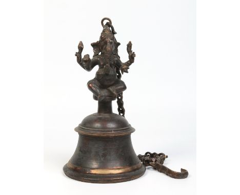 A 19th century Indian bronze hanging bell. With a supporting chain and surmounted with a figure in the image of Ganesh. 38cm 