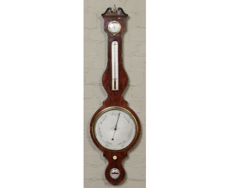 A Regency inlaid mahogany banjo barometer. With brass bezels and silvered dials. Signed G. Manzochi, Hull Warranted, 112cm. C