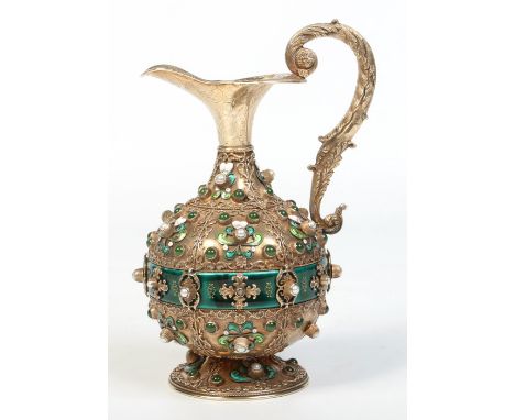 An early 19th century Continental silver gilt wine ewer. With acanthus moulded double scrolling handle, engraved and applied 