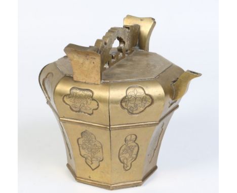 A Japanese bronze octagonal baluster shaped kettle. With open fret handle and shaped reserves engraved with flowers, 19.25cm.