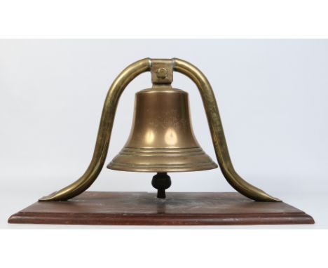 A 19th century bronze bell mounted on a mahogany plinth, 70 cm wide.