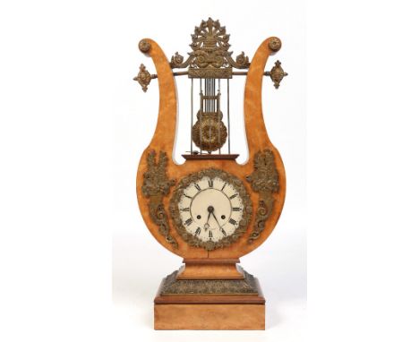 A 19th century French maple lyre clock. With gilt bronze mounts and silvered dial bearing painted Roman numeral markers. Hous