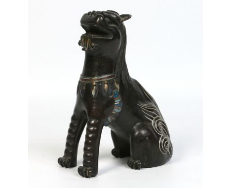 A Chinese bronze model of a seated temple dog having cloisonne decoration, 28cm. Condition Report. To be used as a guide only