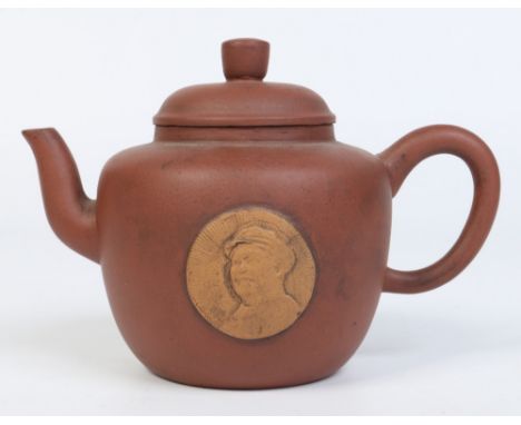 A 20th century Chinese Yixing teapot with a sprigged relief portrait of Mao Zedong. Seal mark and character inscriptions to t