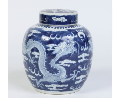 A 19th century Chinese ginger jar and cover. Painted in underglaze blue with dragons chasing a flaming pearl. Four character 