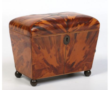 A Regency tortoiseshell dome top tea caddy. With strung inlay and raised on brass ball feet, 18cm wide.  Condition Report. To
