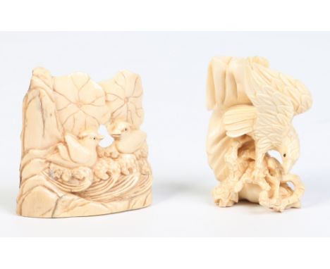 Two Japanese carved ivory netsukes. One formed as a pair of quails on wave scrolls below lilly pads and the other formed as a