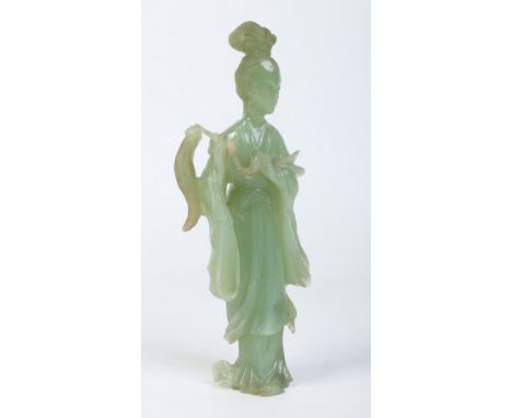 A Chinese carved jade figure of Guanyin. Holding a fly wisp and dressed in flowing robes, 23cm.  Condition Report. To be used