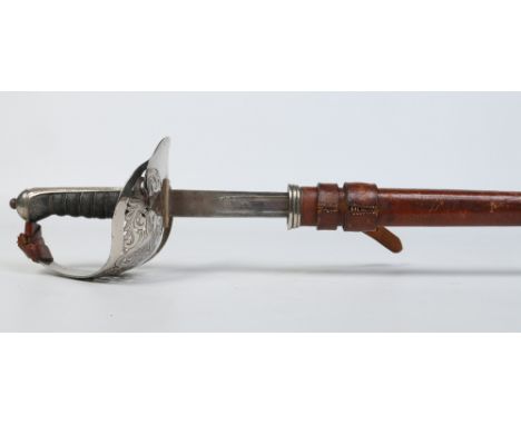 A George V officers sword in leather mounted scabbard by Henry Wilkinson, London. With silvered basket hilt and shagreen grip