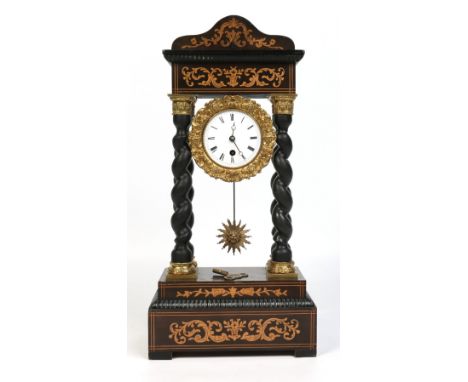 A 19th century French portico mantel clock. With marquetry inlay and having gilt metal bezel and column capitals. Housing a t