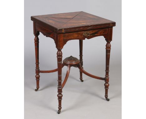 A Victorian rosewood envelope card table. With marquetry inlay, single drawer and raised on turned supports with an x frame c