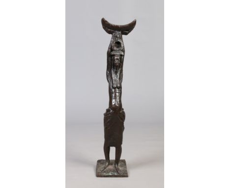 An African patinated bronze statue formed as a tribeswomen holding a stool aloft. Inscribed to the base The Queen Mothers Sto