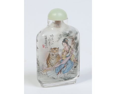 A Chinese carved rock crystal snuff bottle with celadon jade top. Painted inside out with a maiden seated beside a dragon on 