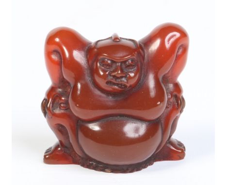 A Japanese carved amber netsuke formed as a Sumo wrestler in a squat position. Signed, 4.5cm. Condition Report. To be used as