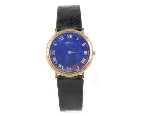 A gentleman's 18 carat gold slim Piaget manual wristwatch. With knurled bezel, gold speckled cobalt blue enamel dial, having 