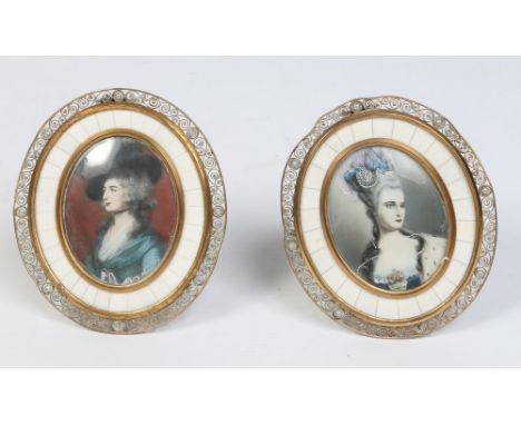 A pair of 20th century portrait miniatures in oval brass filigree strut frames, 13.5cm.  Condition Report. To be used as a gu