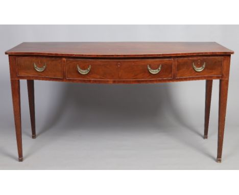 A George III mahogany serpentine serving table of country house proportions. With strung inlay and raised on square tapering 