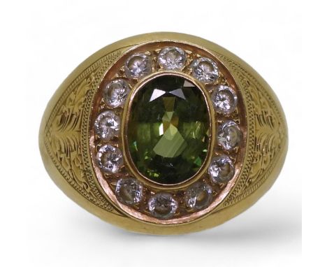 A bright yellow metal ring stamped 90%, with engraved detail shoulders set with a green sapphire and&nbsp; clear gems, size U
