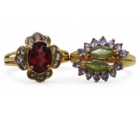 A 9ct gold garnet and green gem cluster ring, size N1/2, and a peridot and purple gem ring, size N1/2, 7.2gms Condition Repor