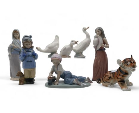 A collection of Lladro and Nao figures of children and geese and a unmarked Lomonosov lion Condition Report:Available upon re