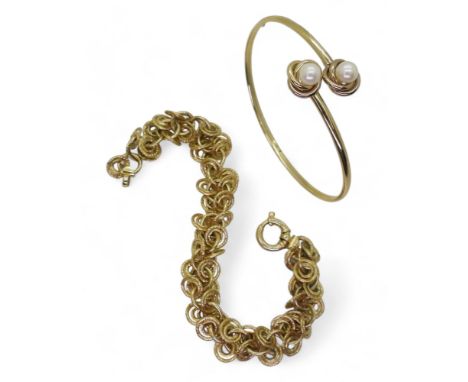A 9ct gold twin pearl bangle, together with a 9ct gold multi link bracelet, weight together 15.4gms Condition Report:Availabl