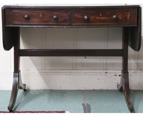 A 19th century mahogany drop-end sofa table with pair of short drawers to one side which is mirrored by faux drawers on the o