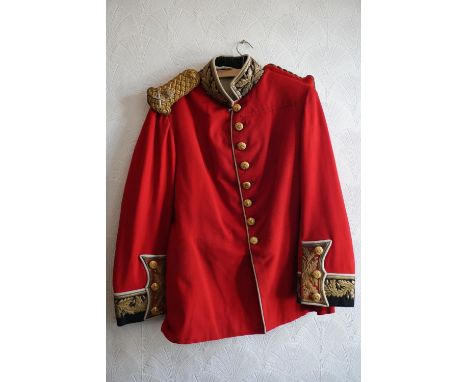 British army uniform, a red tunic jacket with brass buttons, bullion wire knot epaulette with insignia for the rank of Major 