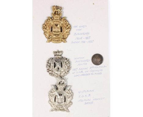 KOSB insignia to include a large brass King's Own Borderers badge 8cm tall, a white metal Scottish Borderers Militia St Andre