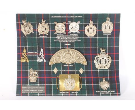 Display board of Kings Own Scottish Borderers KOSB insignia to include an unhallmarked white metal fretted Glengarry cap badg