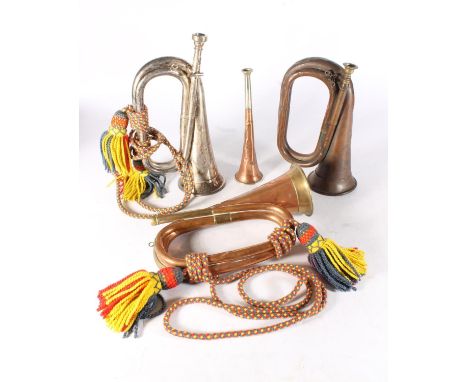 Two copper and brass bugles to include makers George Potter and Co of Aldershot and John Grey of London, a white metal bugle 