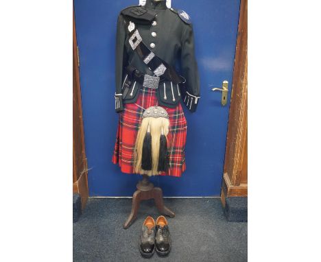 Kings Own Scottish Borderers interest, a mannequin dressed and presented as a KOSB piper with green doublet tunic, Royal Stew
