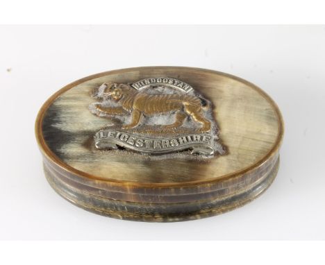 Horn snuff box of oval shape with Leicestershire Regiment cap badge to the top, 10cm long. 