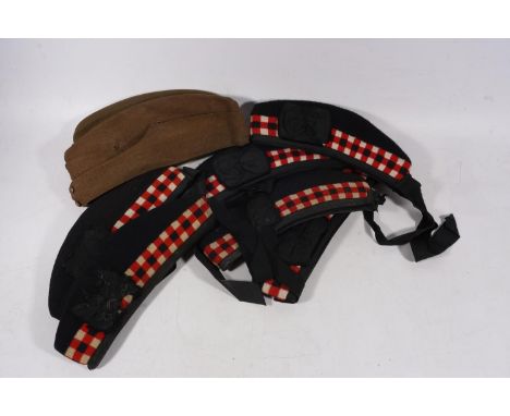Six Scottish military Glengarry caps, two by R Mackie &amp; Co, also two khaki green berets, one dated 1942. (8) 