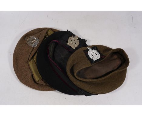 Three military bonnets with Kings Own Scottish Borderers cap badges, one cap dated 1945 and with War Department issue arrow. 
