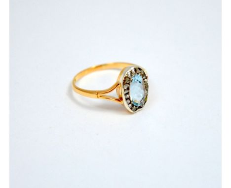 A GEORGIAN STYLE RING, with oval aquamarine within a surround of old cut diamonds, estimated total diamond weight 0.50cts, to