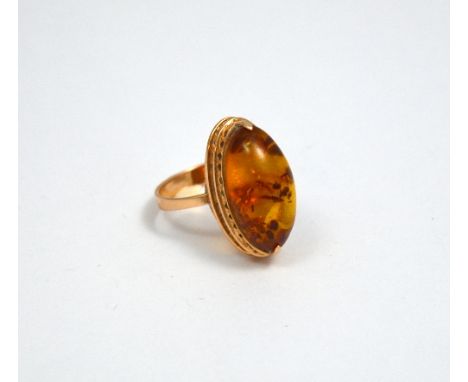 AN AMBER RING, to oval shape amber to the rose gold tapered band, hallmarks for Russia, 583, ring size P