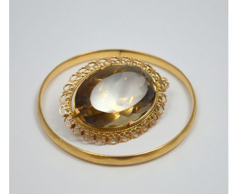 TWO ITEMS OF JEWELLERY, to include a large smokey quartz pendant together with a bangle, stamped 9ct S and P