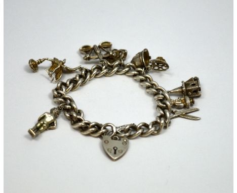 A SILVER CHARM BRACELET, with eight novelty charms to include a policeman's helmet and a church, on a curb link chain with he