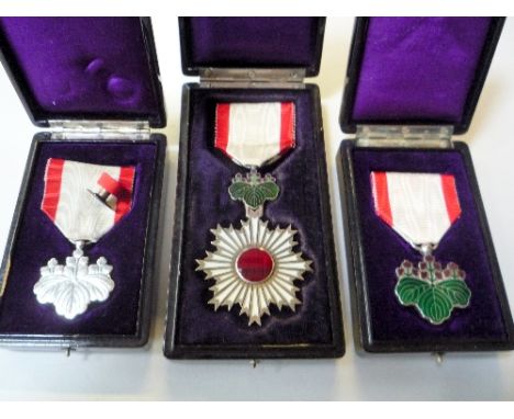 THREE JAPANESE WWII MEDALS, all with original plastic cases, Order of the Rising Sun (4th Class), Order of the Rising Sun (7t