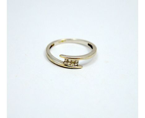 A 9CT GOLD DIAMOND RING, comprising of square shape diamonds within a twisted abstract band, hallmarks for Birmingham, ring s