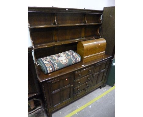 A DARK ERCOL DRESSER, with a central bank of four drawers