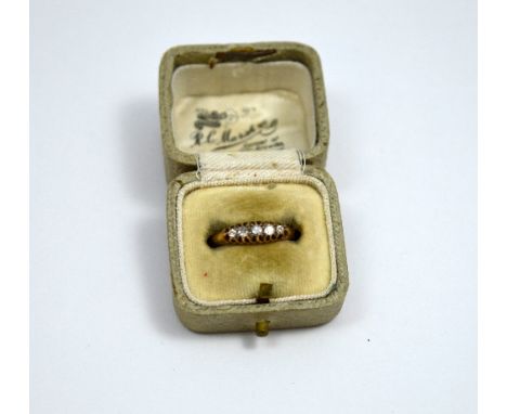 A DIAMOND RING, with five graduated single cut diamonds to the tapered shank, stamped 18ct, ring size J 1/2