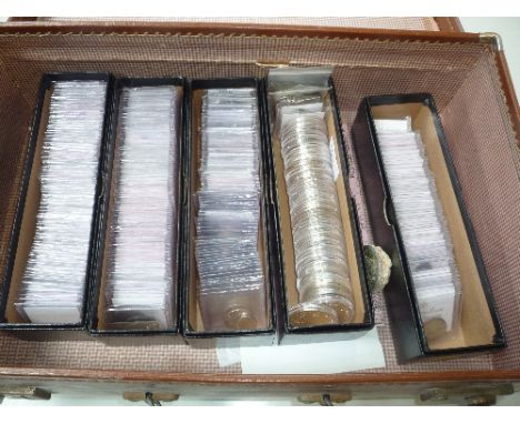 A SUITCASE CONTAINING SIX BOXES OF COINS, two of which contain Morgan Eagle Dollar coins with the other boxes of graded World